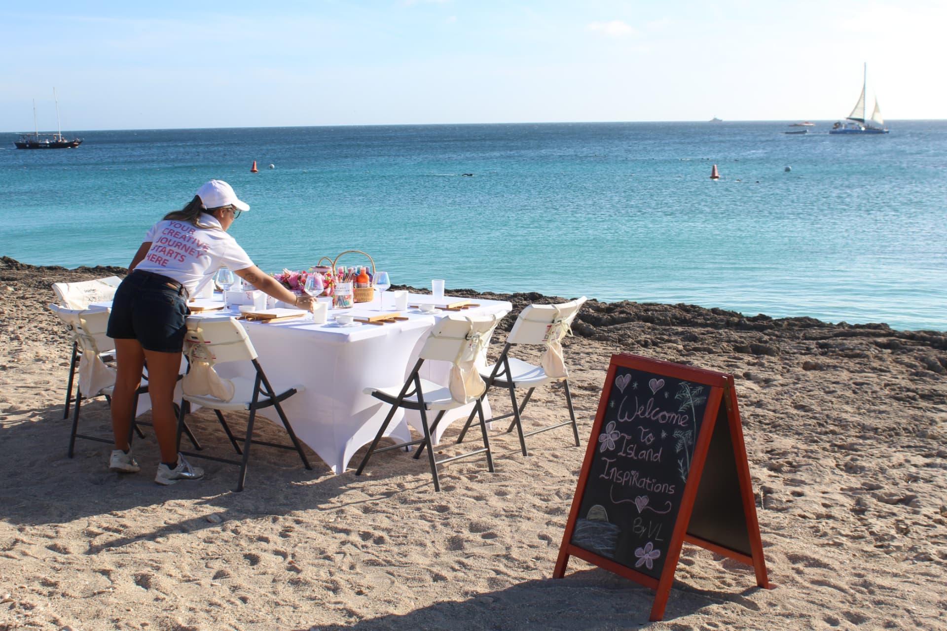 Beach table set up for a custom Island Inspirations sip and paint experience in Aruba